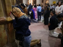 Christian worshippers pray at the Church of the Holy Sepulchre in the Old City of Jerusalem on Easter Sunday, March 31, 2024.