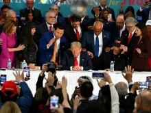 Former president and Republican presidential candidate Donald Trump prays during a roundtable discussion with Latino community leaders at Trump National Doral Miami resort in Miami on Oct. 22, 2024.