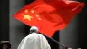 A worshiper waves the flag of China as Pope Francis leaves following the weekly general audience on June 12, 2019, at St. Peter's Square at the Vatican.