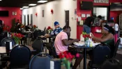 Haitians sit down to eat their meal at a Haitian restaurant in Springfield, Ohio, on Sept. 12, 2024.